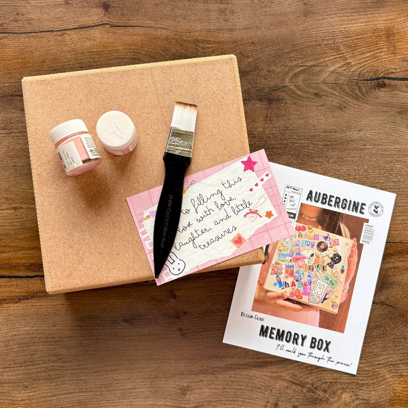 Crafting kit with paint, brush, and decorative items on a wooden surface