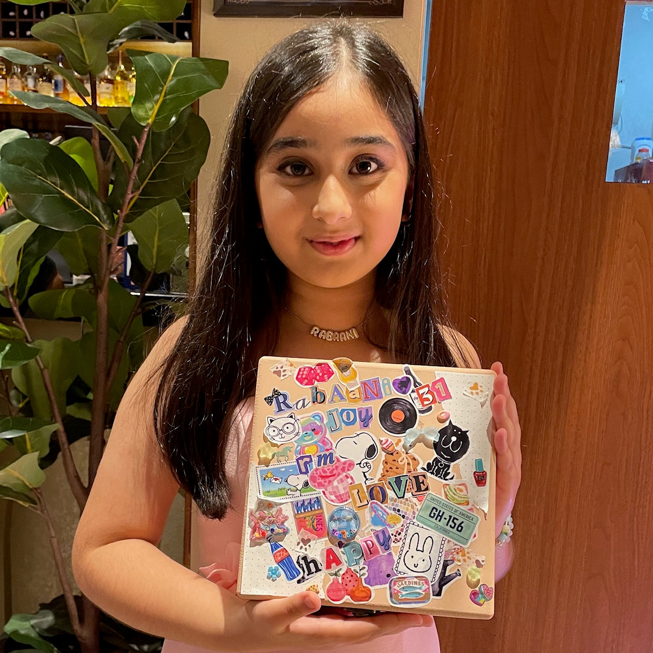 Young girl showcasing her handcrafted box.
