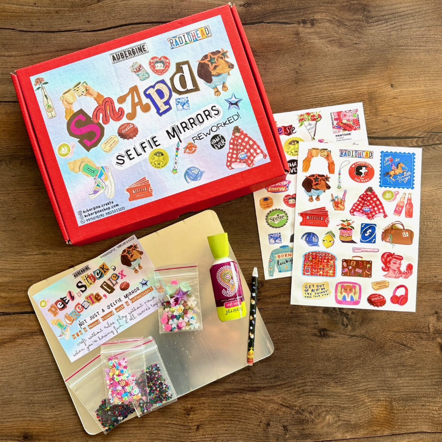 Selfie Mirror DIY Kit and it's contents on a wooden surface.